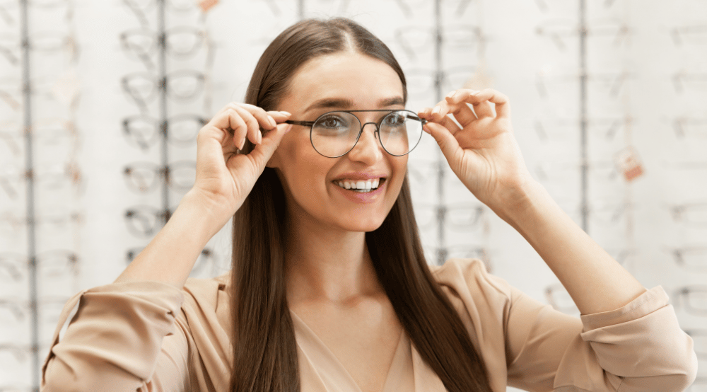 Young woman in optical smiling and wearing glasses